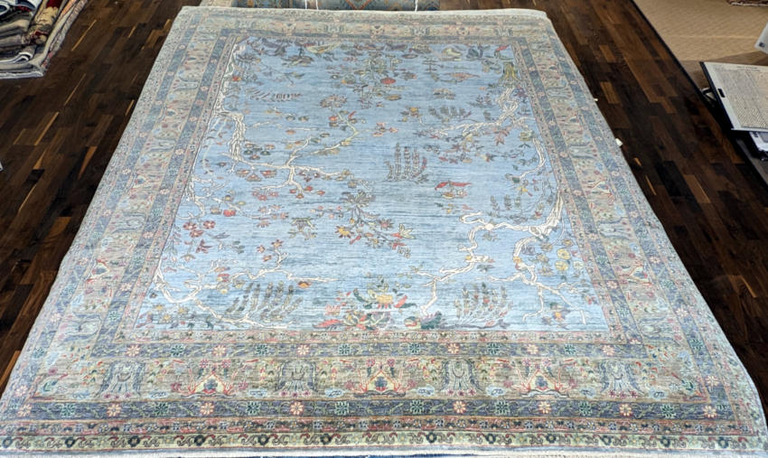 Traditional hand-knotted rug in pale blue.