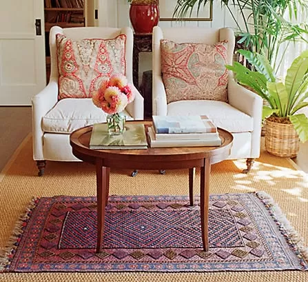 Sisal rug with small hand-knotted rug and two wing chairs