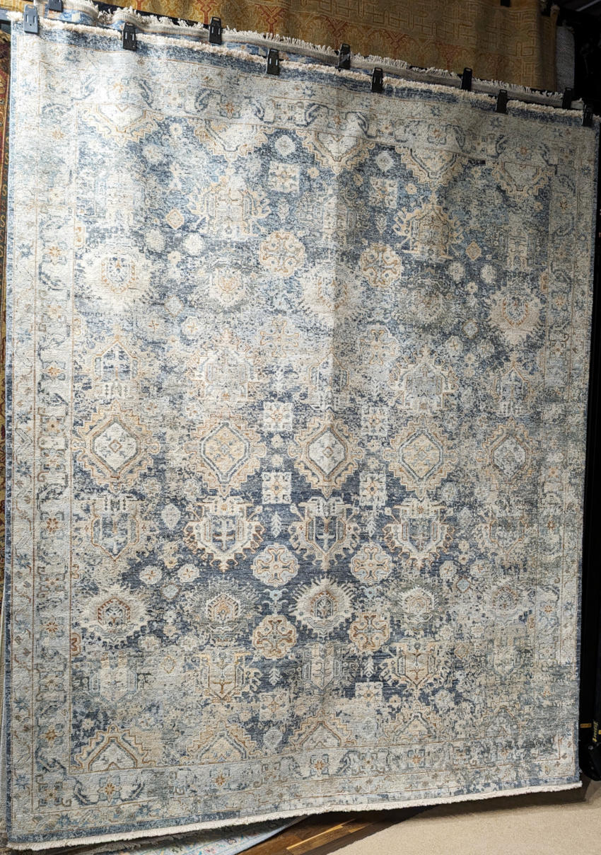 Traditional hand-knotted rug in blue and grey.