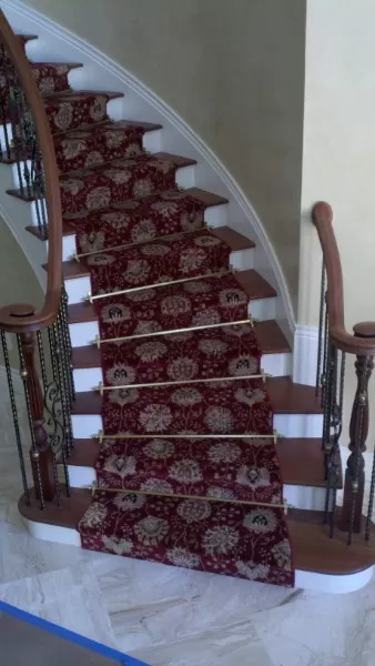 Curving stair case with stair rods.