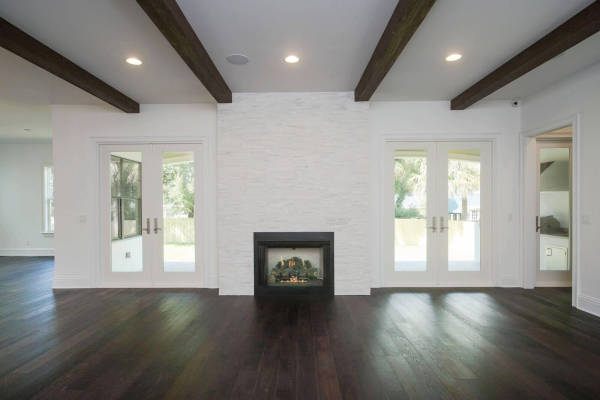 Room with dark, wood floor and fireplace