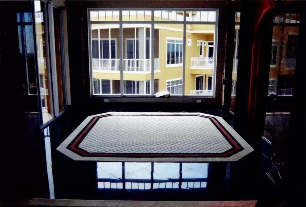 Octagonal rug with inlaid border and field.