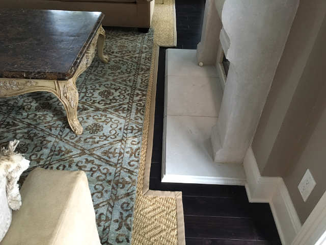 Sisal custom rug layered under traditional rug.