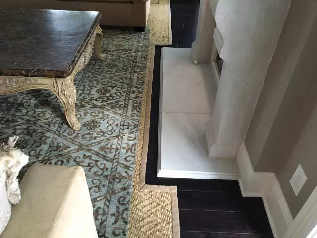 A custom fabricated carpet on top of a sisel-bound custom carpet.
