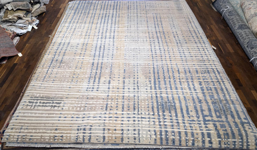 Contemporary hand-knotted rug with blue accents.