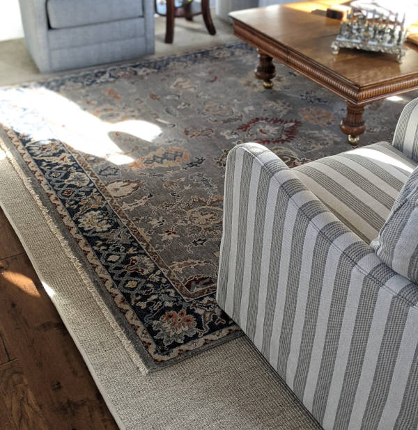 Hand-knotted rug on natural fiber sisal rug.