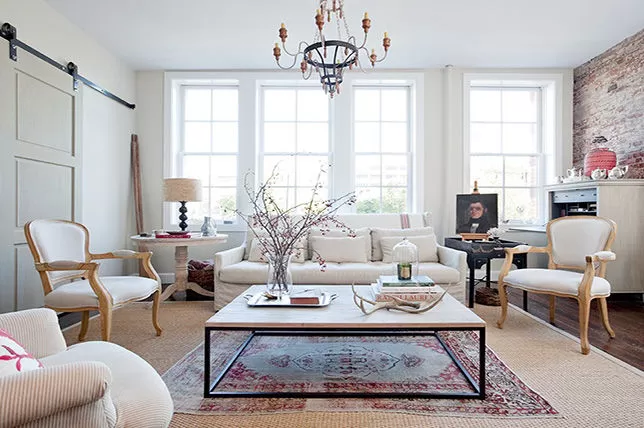 Classic  hand-knotted rug on top of a sisal rug