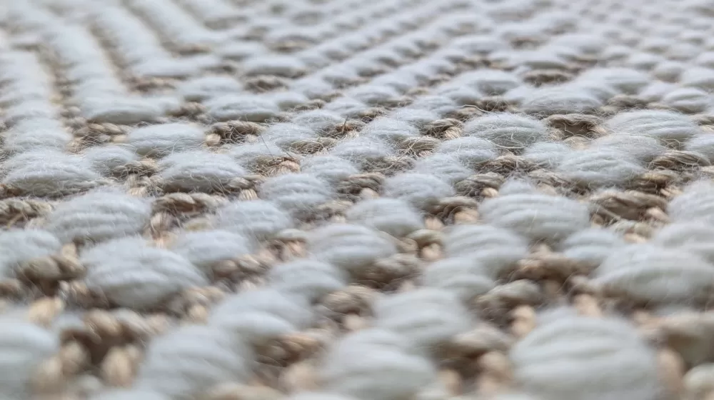 Closeup of surface of hand-loomed rug.