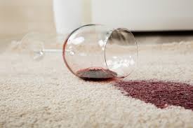 Bright red wine spilled on cream colored carpet.