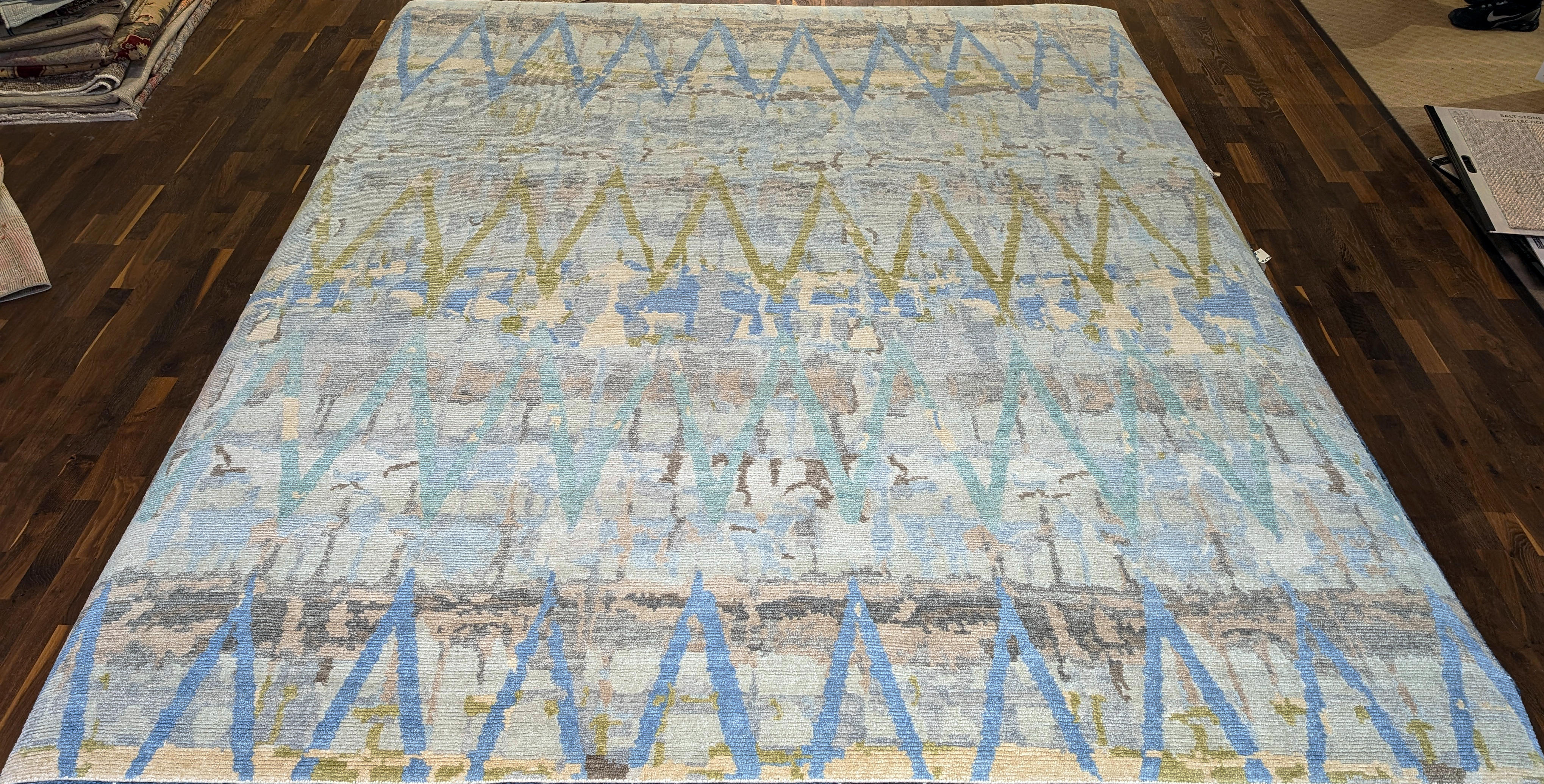 Contemporary hand-knotted rug with blue accents.