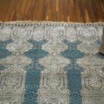 Rug in blue with a decorative stipped pattern