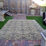 Rug with all-over pattern along side a statue