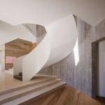 Winding staircase backed by flooring on the wall