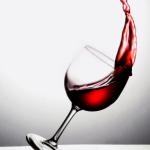 Glass of red wine tipping over